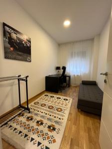 a living room with a bed and a desk at Kej Garden - Two bedroom apartment. in Novi Sad