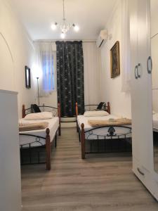 Habitación con 3 camas y ventana en Apartments Colic, en Herceg-Novi
