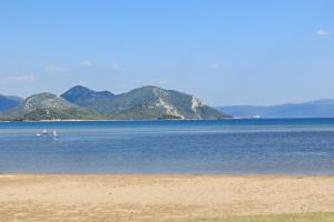 a body of water with mountains in the background at Adriatic Sunrise - Beach House in Blace