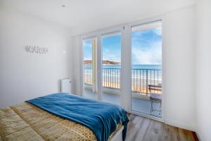 a bedroom with a bed and a view of the ocean at Nahia in Hendaye