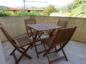 a wooden table and chairs on a patio at Casa Pasqualina in Posada