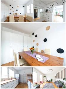 a kitchen with white cabinets and a wooden table at Nice rooftop hostel in Vienna