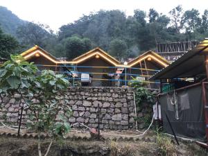 a house is being built with a stone wall at CAMPSITE in Shivpuri