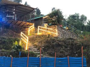 a set of stairs with lights in front of a building at CAMPSITE in Shivpuri