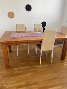 a wooden table with chairs and a cake on it at Nice rooftop hostel in Vienna