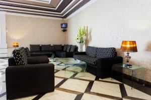 a lobby with couches and tables and a ceiling at Navro Beach Resort in Panadura