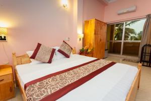 a bedroom with a large bed in a room at Navro Beach Resort in Panadura +28 photos