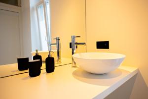 a bathroom with a bowl sink on a counter at Luxury Suites Princess in Antwerp