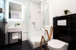 a bathroom with a shower and a toilet and a sink at Art Like Rooms in Zagreb