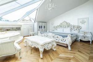 a white bedroom with a bed and a piano at Exquisite Studio in Historic Mansion in Beylerbeyi in Istanbul