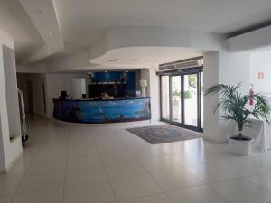 a living room with a large aquarium in the middle of it at Capo Skino Park Hotel in Gioiosa Marea +14 photos