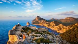 a group of people standing on a cliff overlooking the ocean at Casa Villa Las Encinas in Pollença