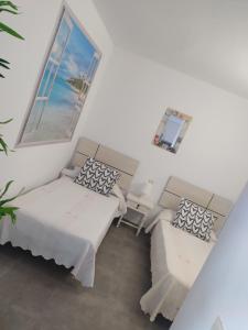 Postel nebo postele na pokoji v ubytování Apartamentos CH 2 + 24 fotografií