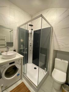a bathroom with a shower and a toilet and a sink at Lovely studio - heart of Menton, near the beach. in Menton