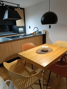 a wooden table in a kitchen with a bowl on it at Apartament 3 Maja 4 in Gorlice