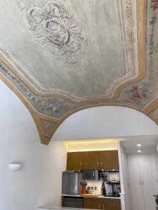 a coffered ceiling with a painting on it at Lovely studio - heart of Menton, near the beach. in Menton