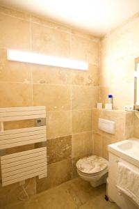 a bathroom with a toilet and a sink at Front de Mer in Hendaye