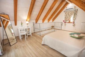 a bedroom with a bed and a table and a window at La Casetta di nonna Olga-Chalet in Agerola