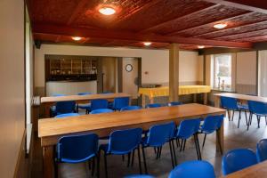 une salle de conférence avec des chaises bleues et une longue table dans l'établissement 't prinsenhof Dranouter, à Heuvelland