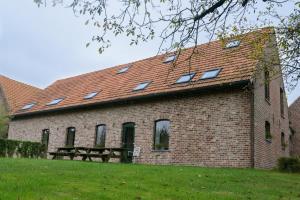 a brick building with a picnic table in front of it at 't prinsenhof Dranouter in Heuvelland