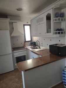 een keuken met witte kasten en een aanrecht bij Costamarina Apartment Top Floor in Cabo Roig