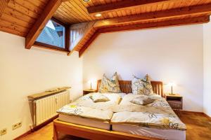 a bedroom with a bed and a wooden ceiling at Cheng in Baden-Baden