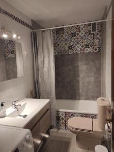 a bathroom with a sink and a toilet and a tub at Vive Huelva MARINA WIFI 300 VFTHU01194 in Huelva