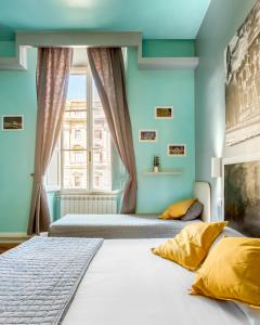 a bedroom with two beds and a window at AmoRoma Suite in Rome