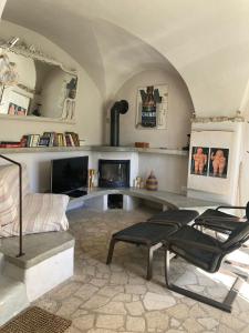 a living room with a table and a chair at Casa Olivia Lacremà in Finale Ligure