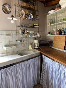 a kitchen with a sink and a counter top at Casa Olivia Lacremà in Finale Ligure +44 photos