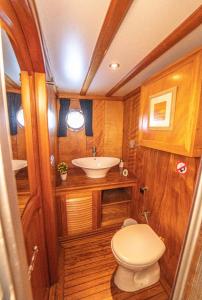 a small bathroom with a sink and a toilet at Hka Neta Yachting in Fethiye