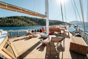 a deck of a boat with tables and chairs at Hka Neta Yachting in Fethiye