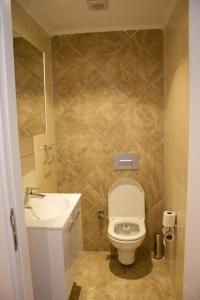 a bathroom with a white toilet and a sink at Vacation home with private pool, Fethiye, Oludeniz in Cedit