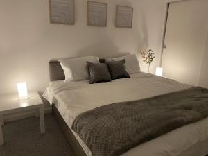 a bedroom with a large white bed with two lamps at Spacious Apartment - Contractors and Family - LGW in Horley