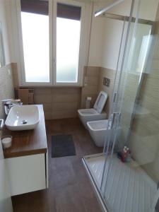 a bathroom with a toilet and a sink and a shower at Casa Vannini in Tirrenia