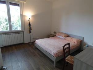 a bedroom with a bed and a table and a window at Casa Vannini in Tirrenia