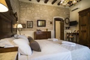 a bedroom with a large bed with white pillows at Il Calamaio in Verona