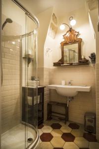a bathroom with a sink and a glass shower at Il Calamaio in Verona