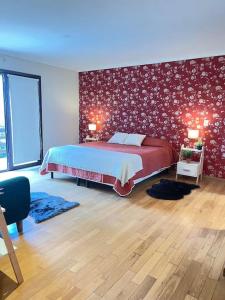 1 dormitorio con cama y pared roja en Precioso Chalet Vista Mar en Mar del Plata