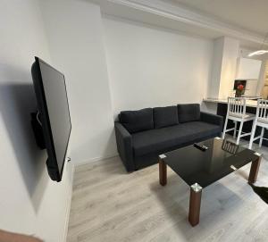 a living room with a couch and a tv at Ferienwohnung Edi in Mülheim an der Ruhr