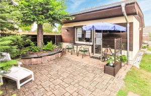 a patio with a table and an umbrella at 1 Bedroom Cozy Home In Stadt Oberharz Am Broc in Stiege