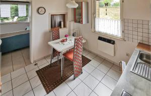 a small kitchen with a table and a table and a counter at 1 Bedroom Cozy Home In Stadt Oberharz Am Broc in Stiege