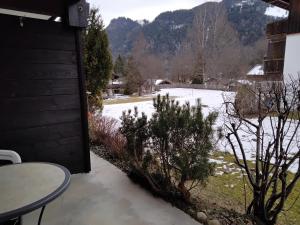 a view of a yard with snow on the ground at ciao-aschau Sachrang Haus Spitzstein FeWo Angelika in Aschau