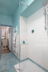 a bathroom with a glass shower and a sink at Il Nido del Canterino in Perugia