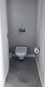 a bathroom with a toilet and a roll of toilet paper at Cottage in Sandton in Johannesburg