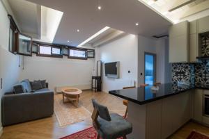 a kitchen and living room with a couch and a table at Farmaki Residence, Plaka in Athens