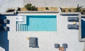 an overhead view of a swimming pool with blue at Annez Villa with Private Pool Panoramic Sea View in Mikonos