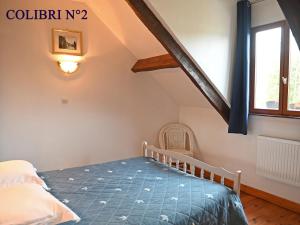 a bedroom with a bed and a window at Le colibri in Étretat