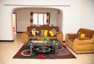 a living room with two couches and a coffee table at KANAMAI PRIME VILLAS in Mombasa