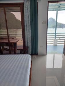 a bedroom with a bed and a view of the ocean at Chislyk Inn in El Nido